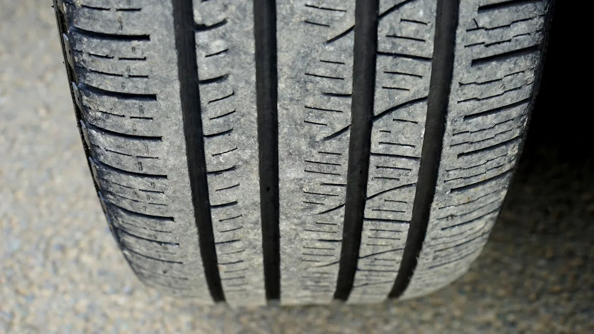 Close-up of a car tyre tread showing groove depth and surface wear, the kind of check to make before driving off