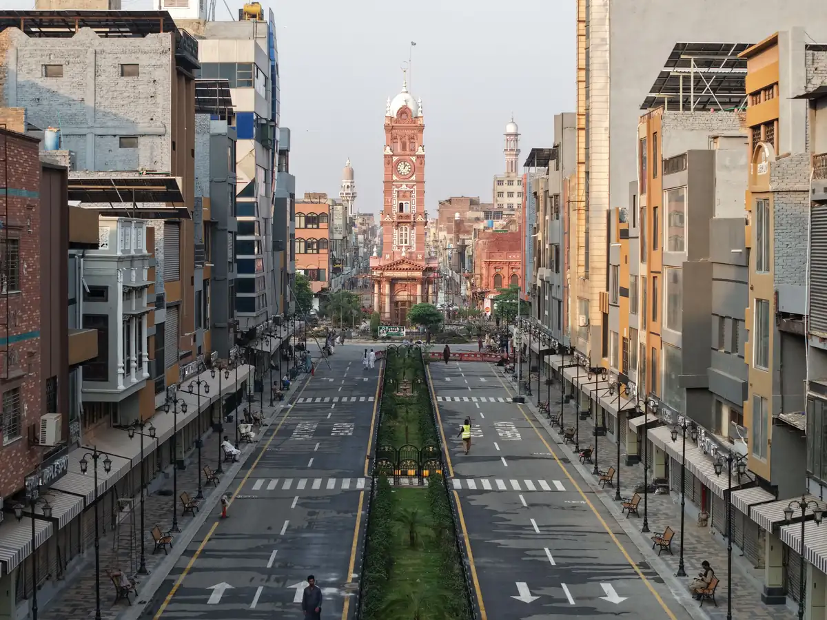 A city street leading towards the Clock Tower in Faisalabad