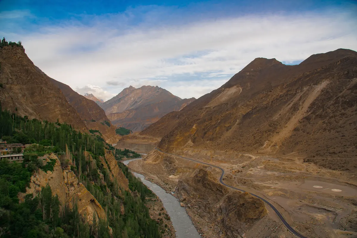 Aerial view of the Hunza river winding between mountains under cloud