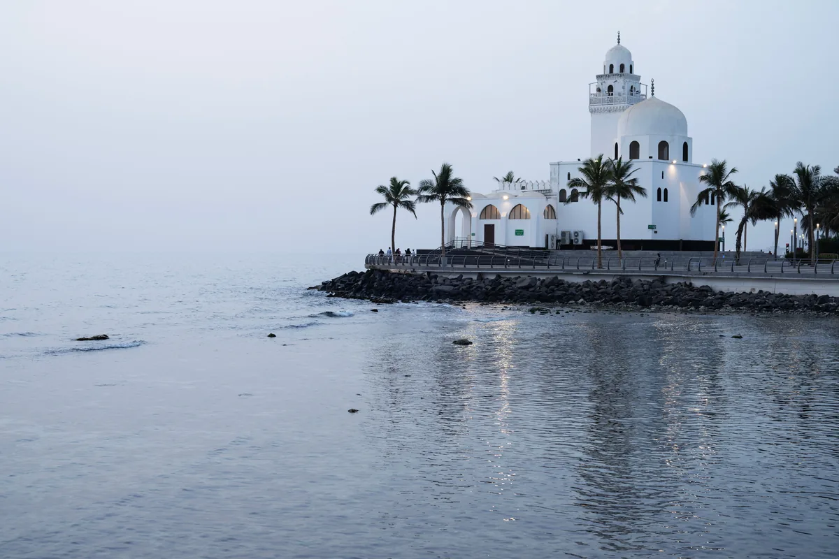 Jeddah waterfront A white mosque beside calm water on the Jeddah waterfront