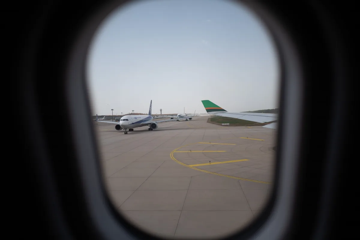 Planes seen through an aircraft window Aircraft on an airport apron seen through a cabin window