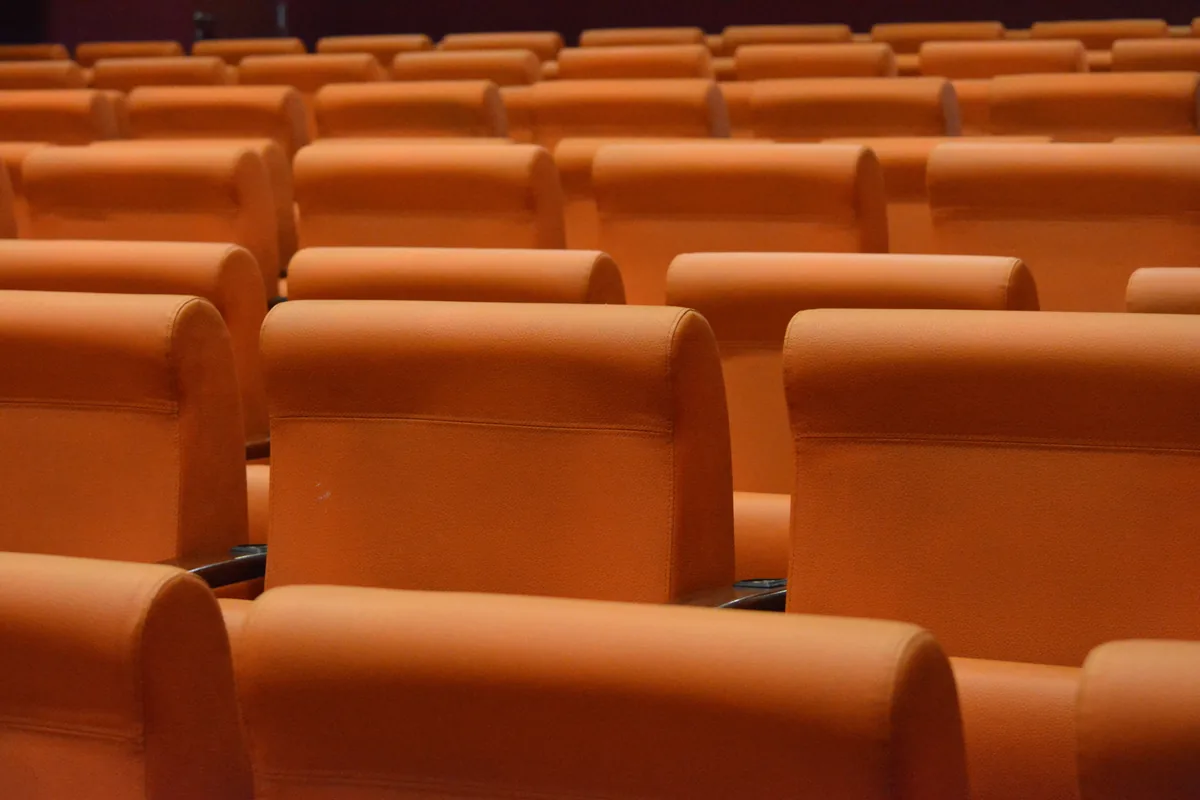 Auditorium seats Rows of orange seats in an auditorium
