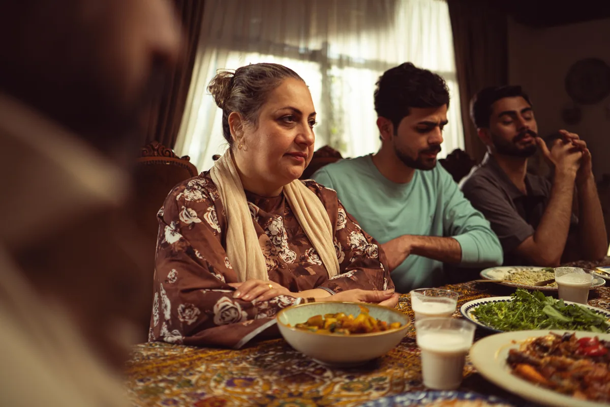 Several relatives sitting together around a dining table