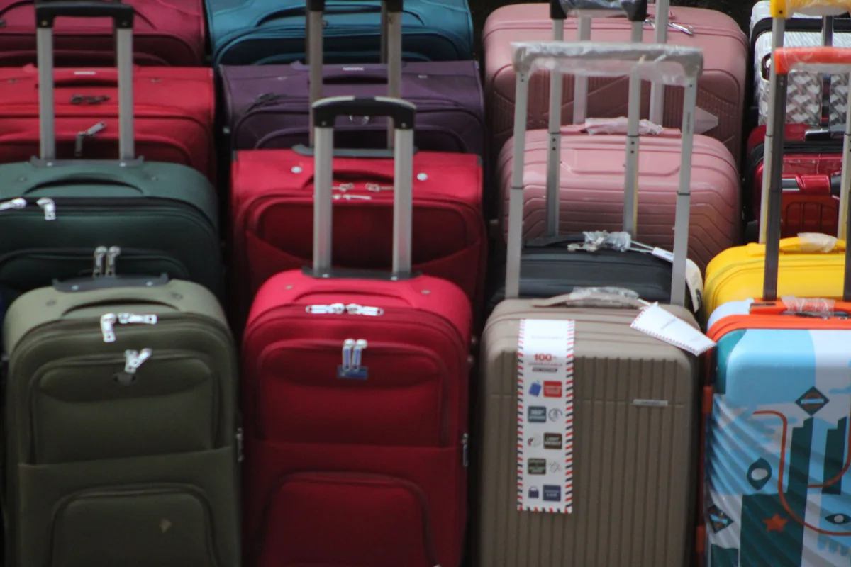 Several colourful travel suitcases stacked together